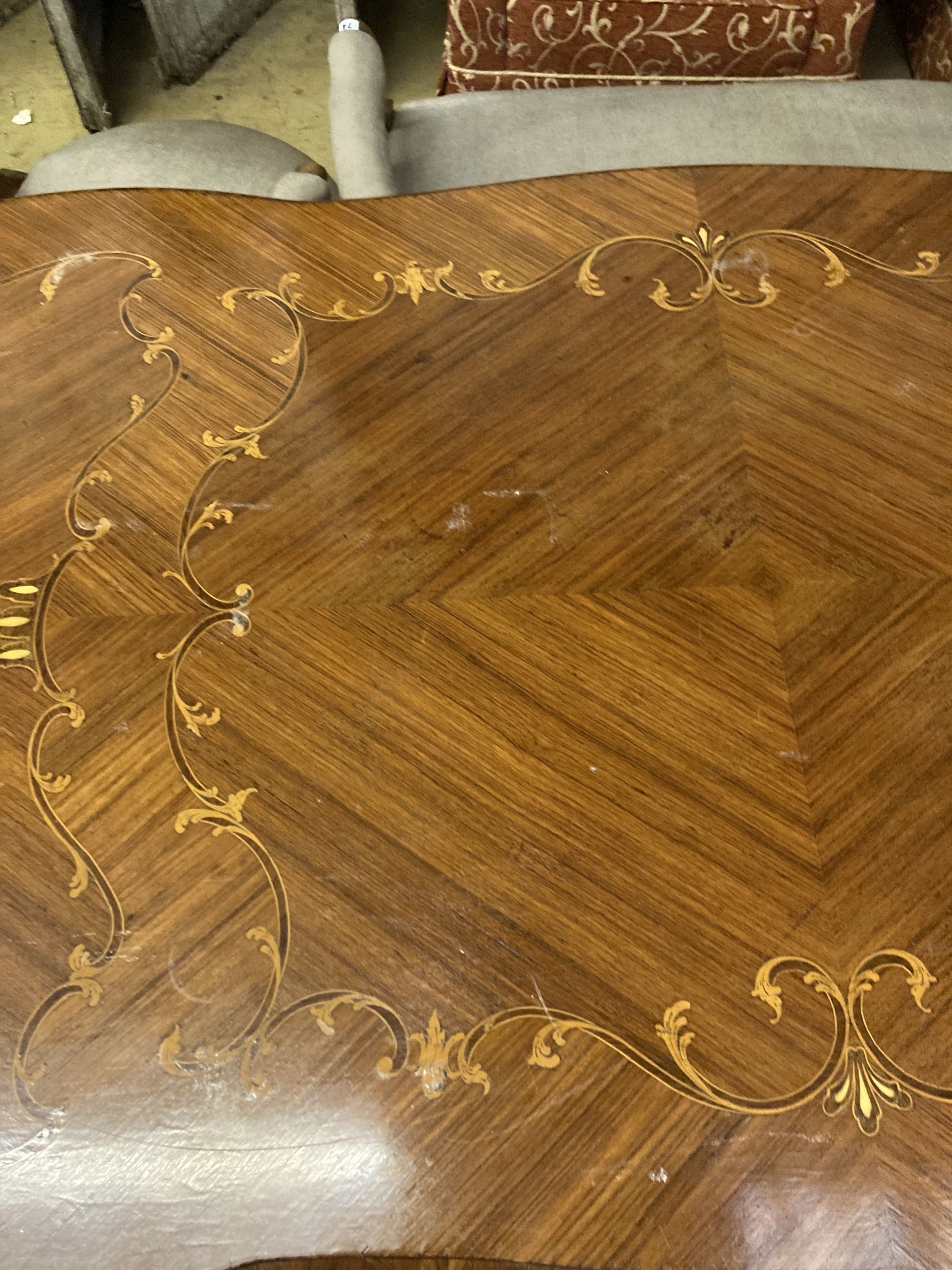 A Louis XVI design marquetry inlaid kingwood serpentine centre table W.196cm. D.90cm. H 79cm.